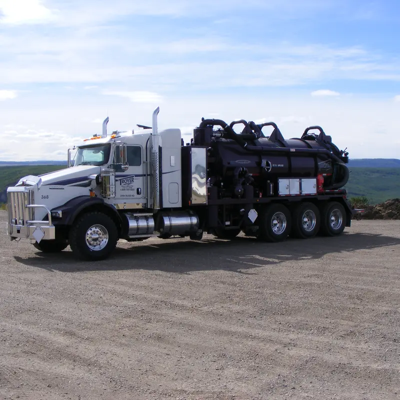 A full Troyer vac unit on a gravel pad under a blue sky