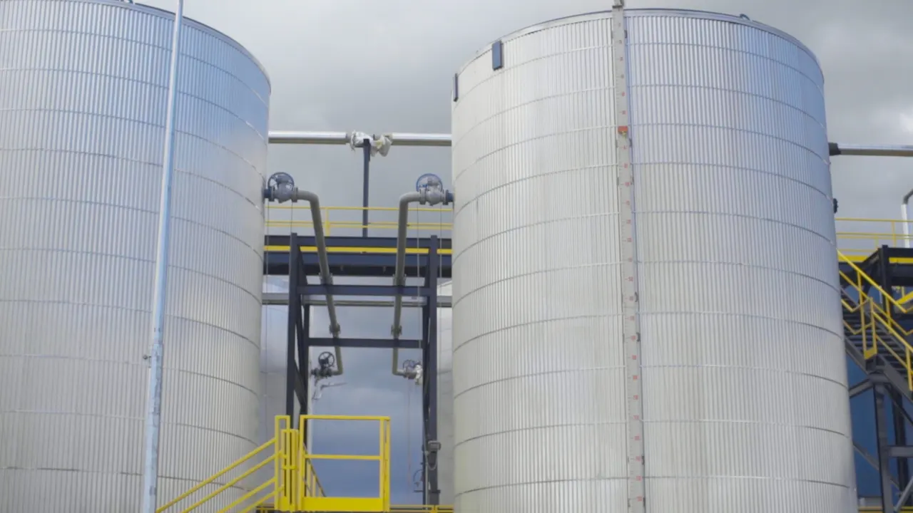 Tall insulated storage tanks with stairways at a Troyer tank farm