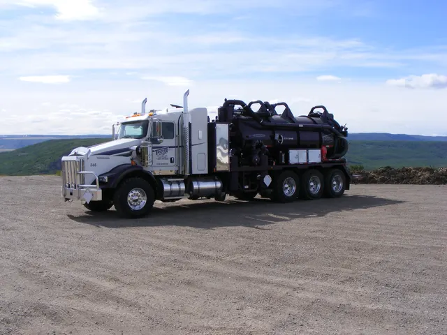 A Troyer vac truck parked on a gravel pad